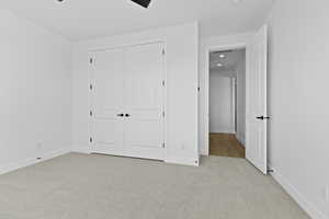 Unfurnished bedroom with light carpet, a closet, recessed lighting, and ceiling fan