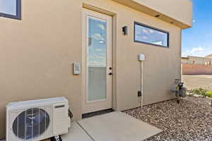 Entrance to property featuring stucco siding and a patio area