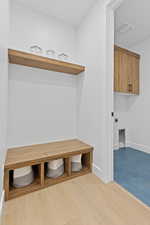 Mudroom with baseboards and light wood-type flooring