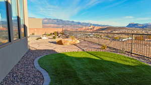 Fenced backyard featuring a mountain view and a patio