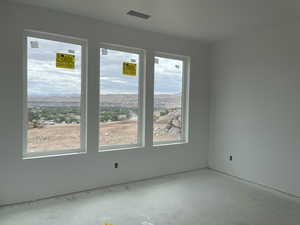 Unfurnished room featuring concrete floors and a mountain view