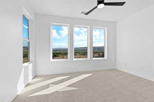 Spare room with carpet flooring and ceiling fan