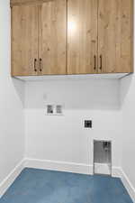 Laundry area featuring cabinet space, hookup for an electric dryer, and hookup for a washing machine