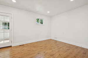 Spare room featuring light wood-type flooring and recessed lighting