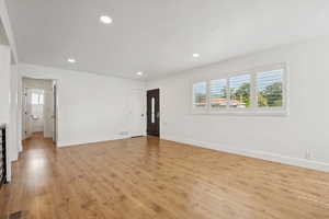 Empty room featuring plenty of natural light, light wood finished floors, and recessed lighting