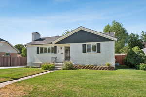 Single story home with brick siding and a chimney