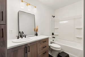 Basement bathroom with vanity and shower/tub combination