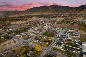 Aerial view at dusk of a mountain view, property boundaries highlighted, and a residential view