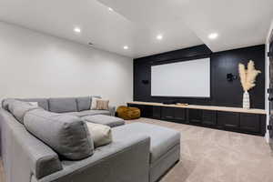 Home theater room featuring light carpet and recessed lighting