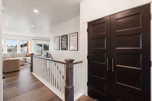 Entryway with wood finished floors and recessed lighting