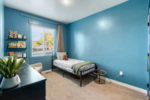 Carpeted bedroom featuring baseboards