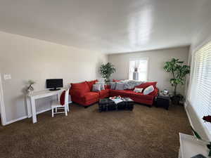 Living area with carpet flooring and a desk