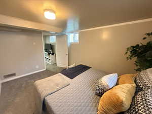 Carpeted bedroom featuring baseboards