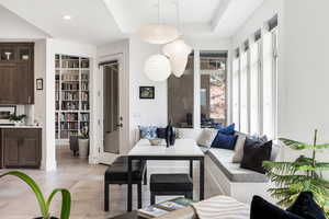 Living area with built in features and light tile patterned floors