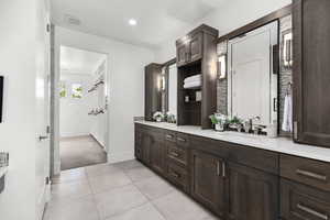 Full bathroom with double vanity, tile patterned flooring, and recessed lighting