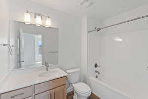 Bathroom with vanity, shower / tub combination, and wood finished floors