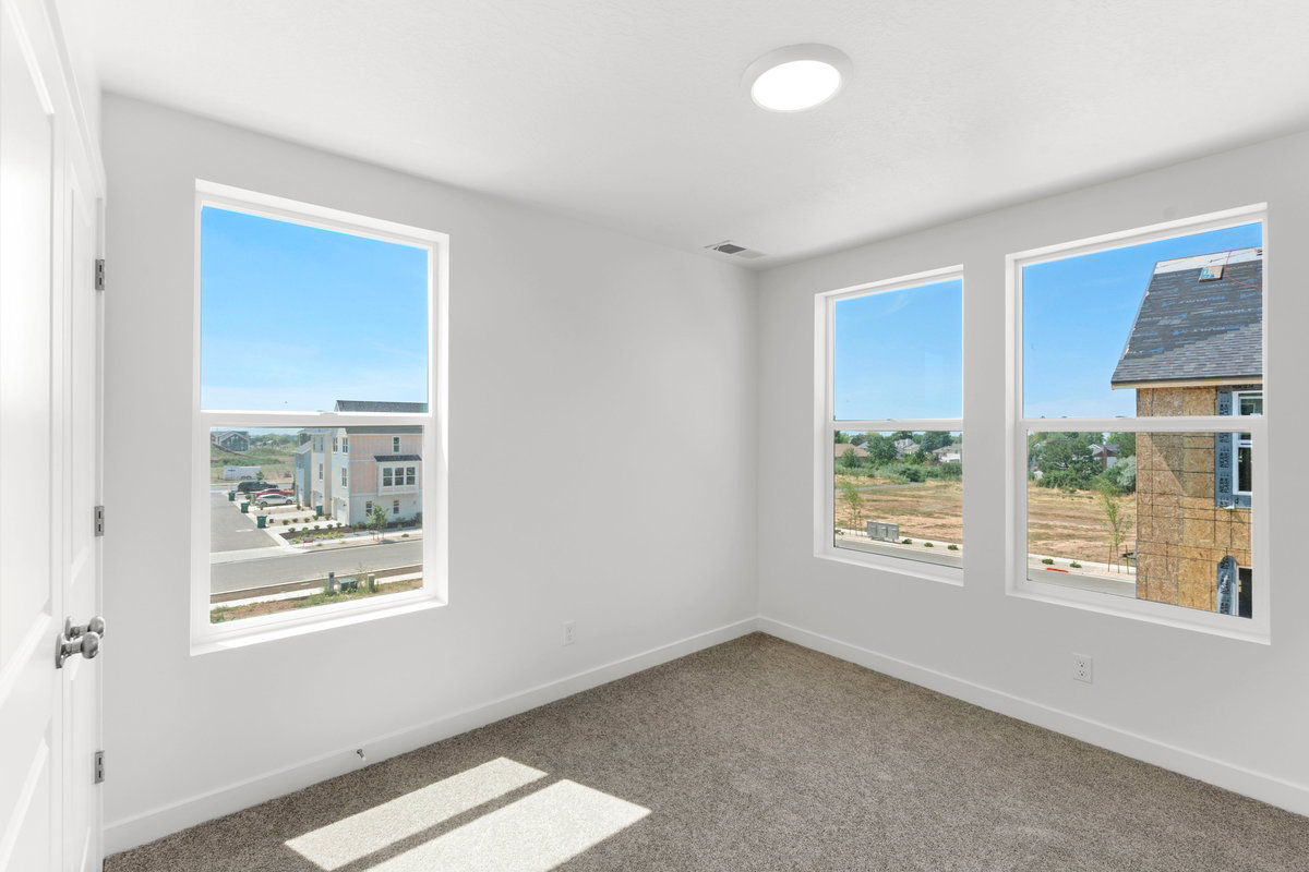 Carpeted spare room featuring baseboards