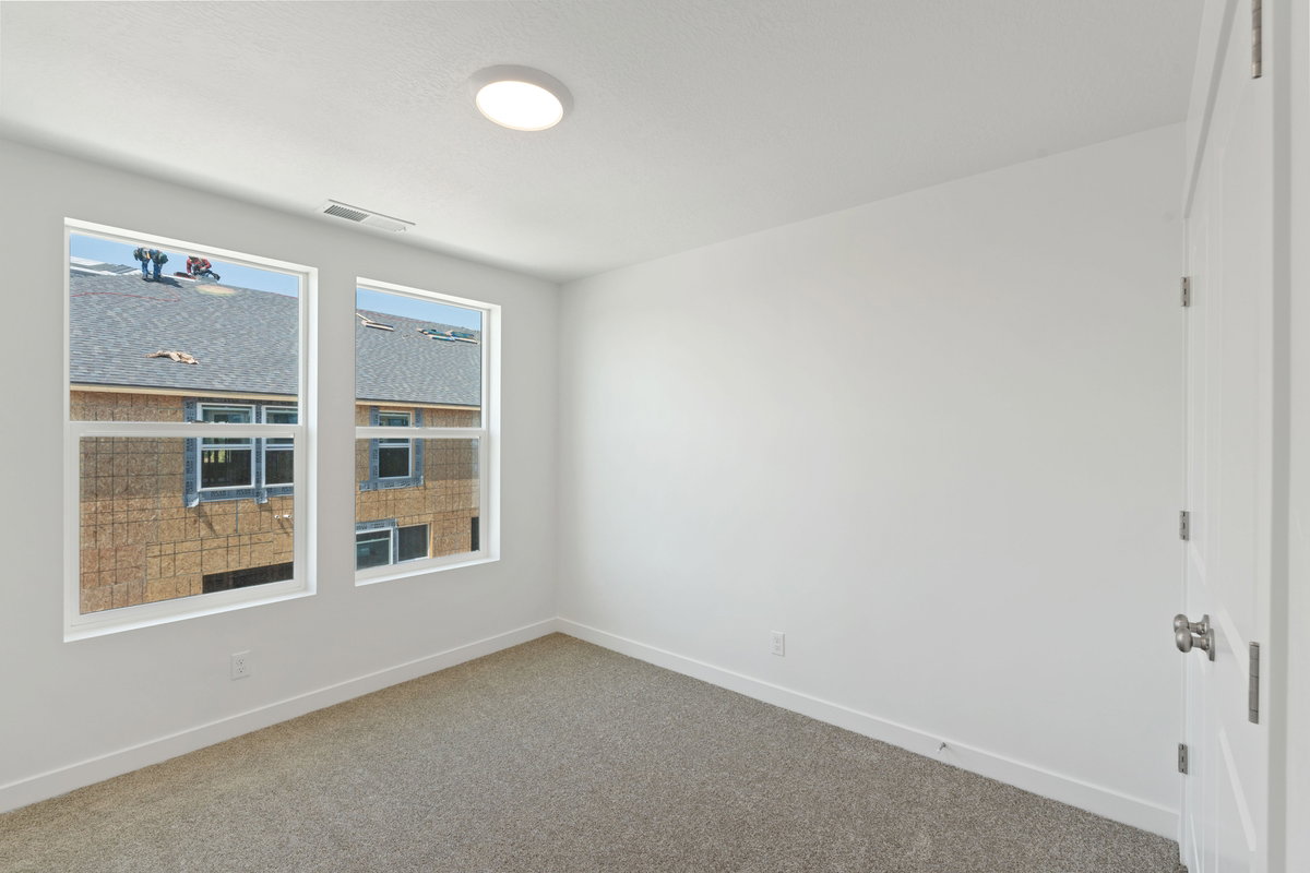 Empty room with carpet and baseboards