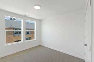 Empty room with carpet and baseboards