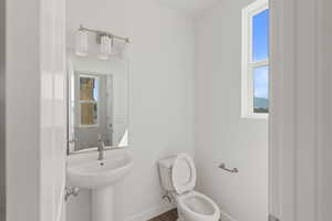 Bathroom featuring toilet and wood finished floors