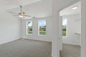 Empty room featuring carpet and a ceiling fan