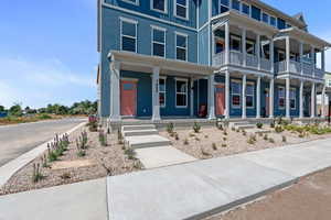 View of front facade featuring a porch and a balcony
