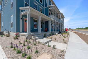 View of front of property with a porch and stucco siding
