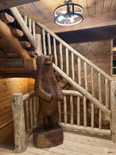 Stairway with wooden walls, wood ceiling, and wood-type flooring