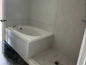 Full bathroom featuring a garden tub