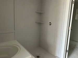 Full bathroom featuring a shower stall