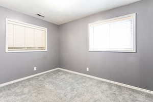 Carpeted bedroom featuring baseboards