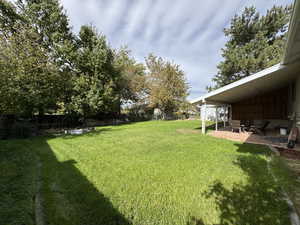 Fenced backyard with a patio