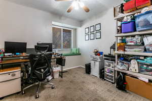 Bedroom/Office with ceiling fan, carpet floors, and a textured ceiling