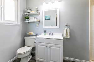 Primary bathroom featuring toilet and vanity