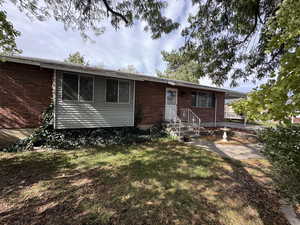 View of front facade featuring brick siding and a front lawn