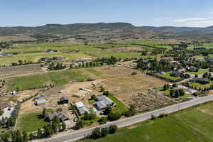 Aerial view of property's location featuring rural landscape and a mountain backdrop