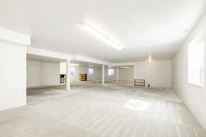 Below grade area with carpet flooring and plenty of natural light