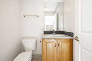 Half bathroom featuring vanity and tile patterned floors