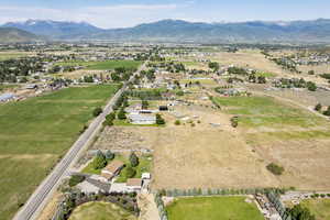 Aerial view of property and surrounding area with a mountainous background