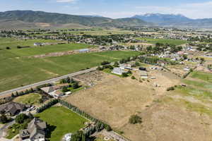 Aerial view of property and surrounding area with mountains and rural landscape