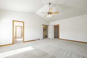 Unfurnished bedroom with lofted ceiling, light colored carpet, and ceiling fan