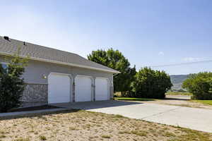 Garage with concrete driveway and a mountain view