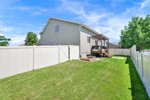 Fenced backyard featuring a deck