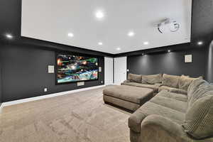 Home theater room with carpet floors and recessed lighting