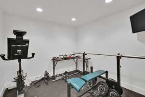 Exercise area featuring recessed lighting and baseboards