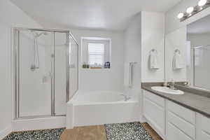 Bathroom with vanity, a stall shower, a bath, and tile patterned floors