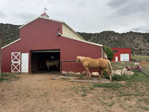 View of barn with a mountain view