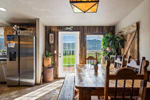 Dining area featuring stone finish flooring and wooden walls