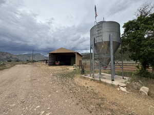 View of pole building featuring dirt driveway, a carport, and a mountain view