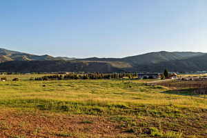 View of mountain backdrop featuring rural landscape and agricultural land